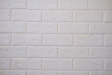 The artificial background resembles a textured and white brick wall. Artistic walls for interior decoration and function to dampen echoes because material is made of sponge.
