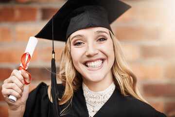 Woman, graduation and portrait of a university student with a diploma and smile on face. Female...
