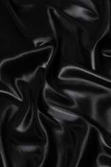 Silk fabric, abstract wavy black satin fabric background.