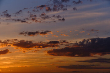 Clouds on a blue sky background during sunset.