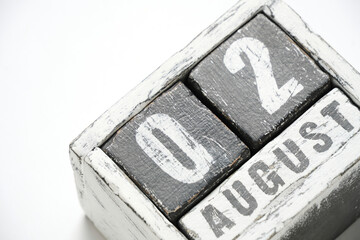 August 02, wooden calendar with cubes on a white background.
