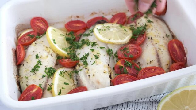 Baked cod fillet with cherry tomatoes and butter.
