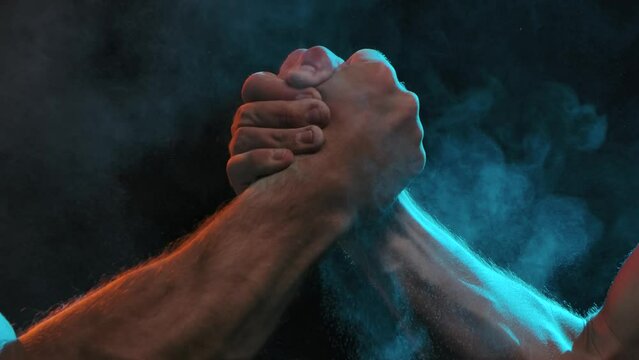 Sports Handshake of Two Muscular Men on a Black