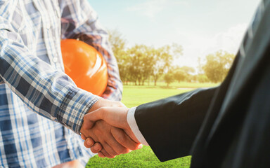 Business handshake land purchase. Businessman handshake a deal with a realtor for the construction...