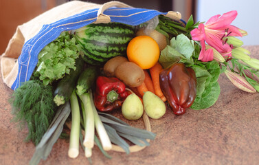 Shopping bag full of vegetables and fruit on the table, grocery purchases for vegan or vegetarian people, healthy eating concept