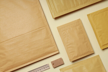 Flat lay with blank packages on beige background