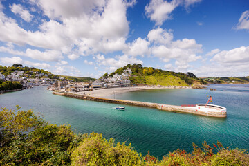 Fishing boats in the bay at Looe Harbour  and beach in Cornwall