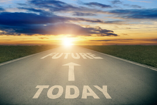 Asphalt road with white arrow sign and today to future text goes to horizon. Sunshine on horizon and the road strigt away forward. Clear and positive perspectives ahead.