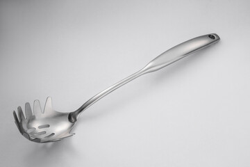 Stainless steel tableware and kitchen utensils placed on the desktop