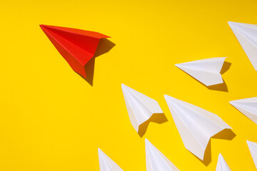 Business, startup and sponsorship concept with paper planes on yellow background