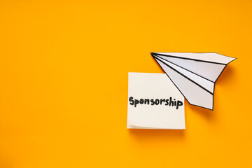 Concept of sponsorship with paper plane on yellow background - obrazy, fototapety, plakaty