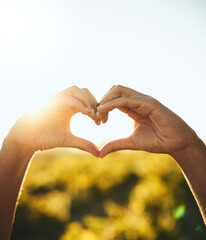 Woman with heart hands, nature and sun, sustainability and eco friendly earth care with natural farm in countryside. Conservation, sustainable farming and girl with love hand sign or kindness emoji.