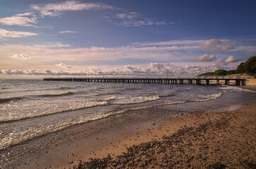 Charming morning seaside landscape. Popular pier in Gdynia Orlowo on the Baltic Sea in Poland.