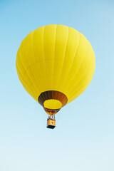 view of air balloon with basket flies on sunset