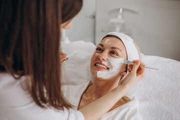 Woman in mask on face in spa beauty salon.