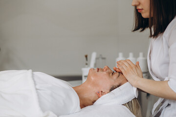 Obraz na płótnie Canvas Face peeling mask, spa beauty treatment, skincare. Woman getting facial care by beautician at spa salon