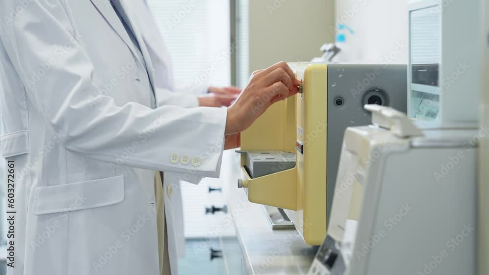 Poster researcher using experimental equipment in laboratory.