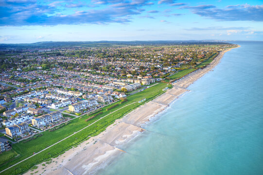 Aerial photo of Rustington Village in West Sussex on the seafront by Broadmark Lane looking towards East Preston.