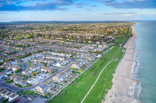 Aerial view of Rustington Village in West Sussex on the seafront by Broadmark Lane looking towards East Preston.