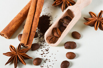 Background for a menu - coffee beans in scoop with spices, cinnamon stick, star anise