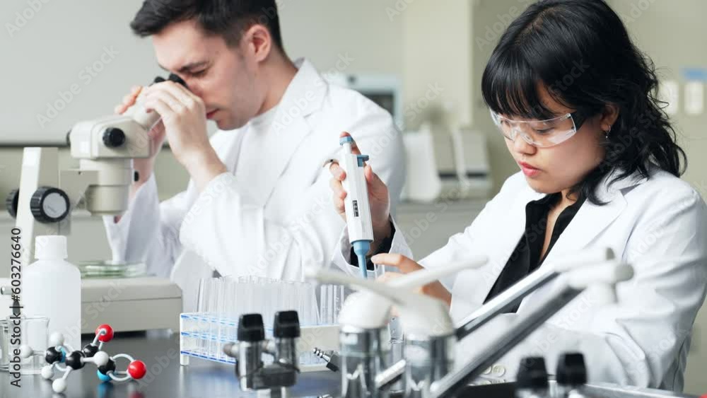 Poster group of multinational scientists working in laboratory.