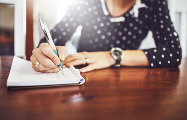 Woman, writing and home table with notebook and day schedule in a dinning room. Lens flare, female person and to do list in a house with notepad, page and book for planning to write a article