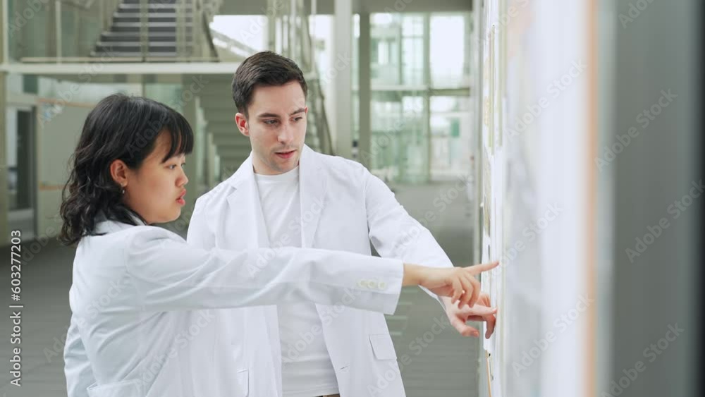 Poster group of multinational scientists meeting in laboratory.
