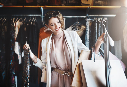 Stylist, Rich Or Happy Woman Shopping In Boutique Store Looking At Clothes Or Choosing Her Favorite Style. Choice, Decision Or Female Designer With Trendy Apparel Picking An Outfit Or Classy Fashion