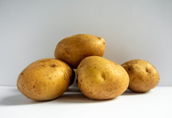 fresh potatoes just harvested on white background