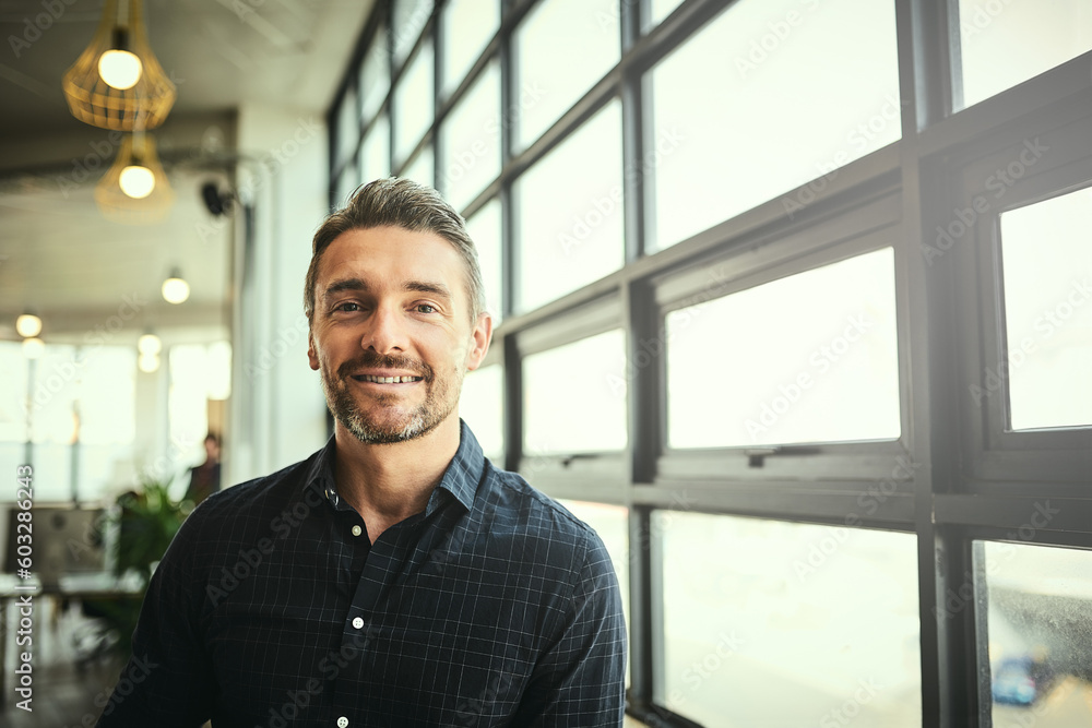 Wall mural Portrait, smile and happy man at office window, creative startup and business project for entrepreneur at design agency. Proud boss with creativity, job ideas and focus, businessman with confidence.