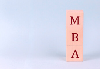 MBA on wooden cubes on a blue background