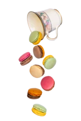 Poster Flying macarons falling from a vintage cup isolated on transparent background © Delphotostock