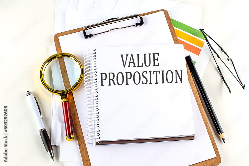 Poster value proposition text on notebook with clipboard on white background