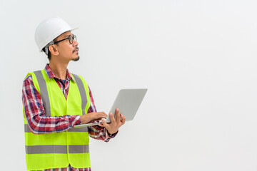 Asian male architect or engineer wearing white hard hat holding laptop isolated on white background Copy space over a white studio background.
