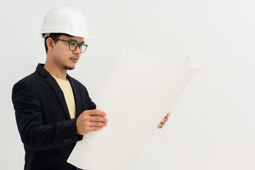 Asian handsome young man architect engineer looking at construction blueprints Engineering and...