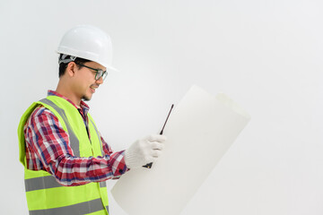 Asian handsome young male architect engineer looking at blueprints Engineering and architecture concept isolated on white background. Copy Space Posing Over White Studio Background
