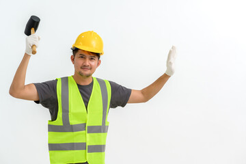 Portrait of male construction worker wearing hard hat holding rubber mallet making hammer strike...