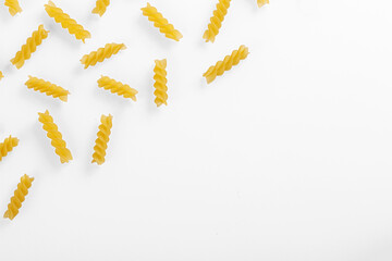 Pasta products in the form of a spiral, texture, on a white background