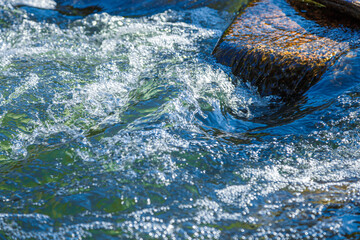 flow of water and spray from a stone