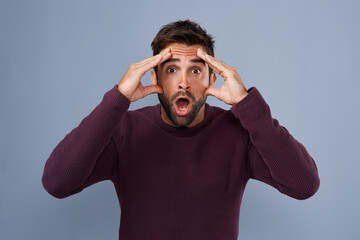 Portrait, wow and man in studio mind blown by gossip, drama or secret against grey background. Omg,...