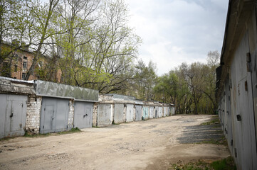 Old garages. An abandoned road. Photo of old abandoned buildings.