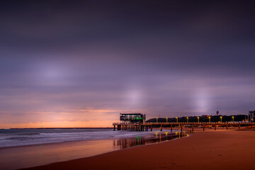 Pier on the beach sunrise