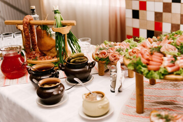Table with rustic meat delicacies and pickles