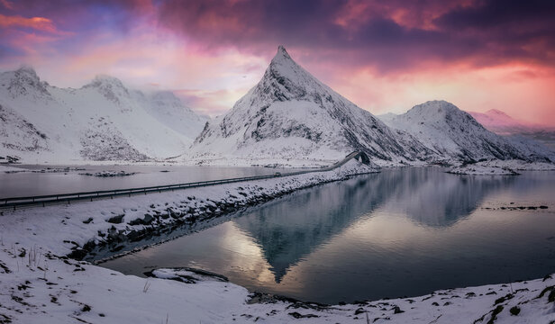 Fredvang bridge, Lofoten islands, Norway. Mountains and road. Landscape in the winter during sunset. Bridge adove ocean.