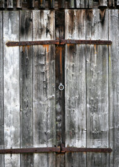 Antique old weathered wooden barn door with forged metal parts. Rustic Style. Copy space.