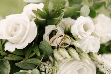 Beautiful wedding bouquet with protea and roses, wedding rings