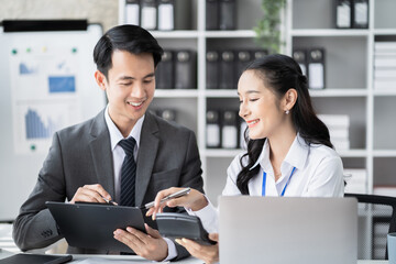 Businessmen team or financial data analysts working with tablets and laptop computers and data graphs together. Plan to analyzing projects in the office.