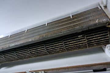 Pictures of air conditioners with dirty dust on the air conditioner filter and dirty air conditioner filters need to be cleaned.