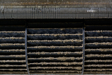 Close up of dirty dust on the air conditioner filter. Accumulation of dust requiring replacement of...