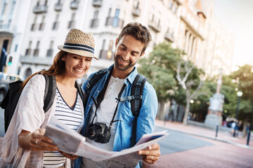 Couple, tourist and a map in a city for travel on a street for direction or location search. Man...